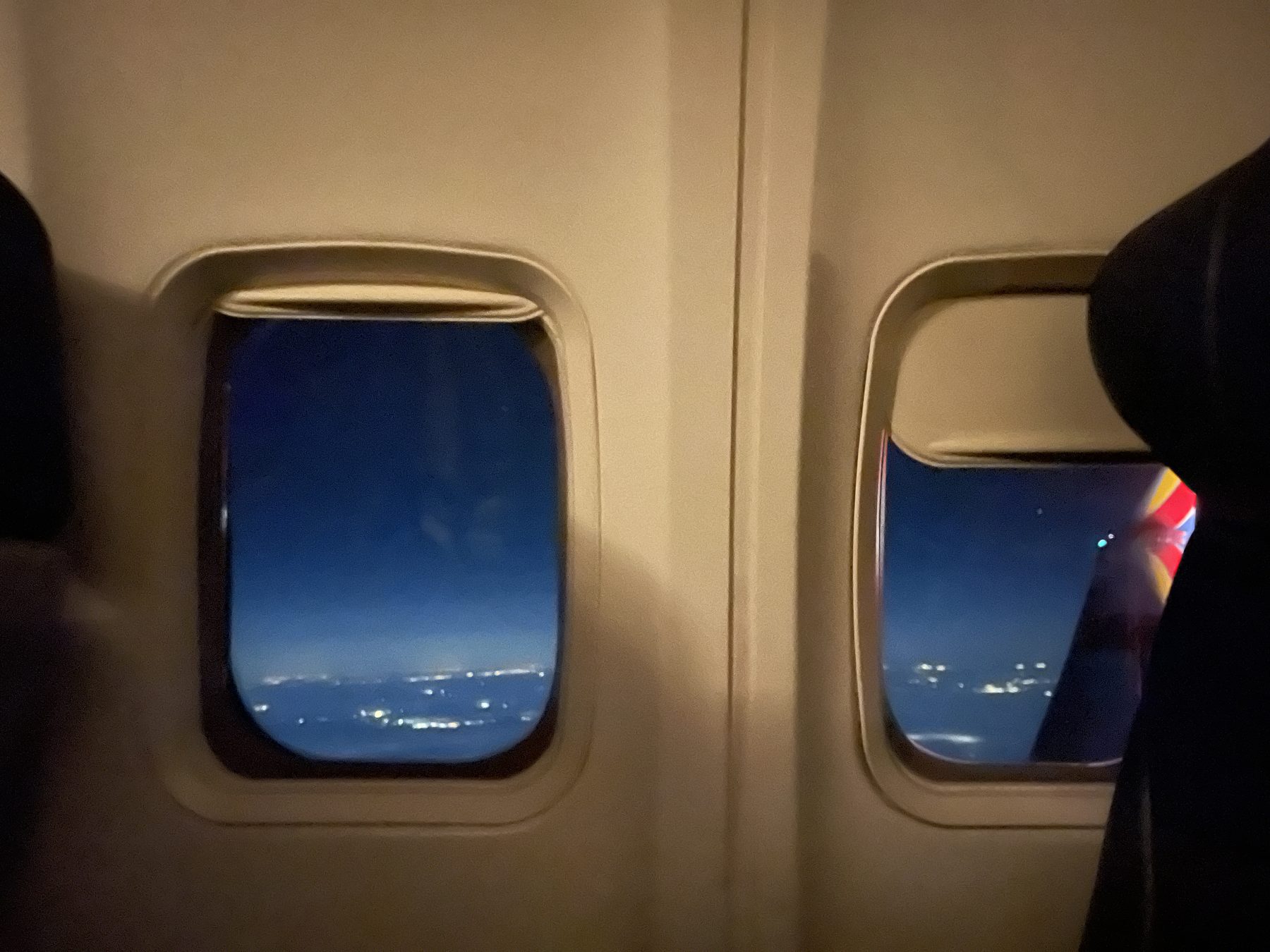 Windows outside of the plane lit with incandescent light