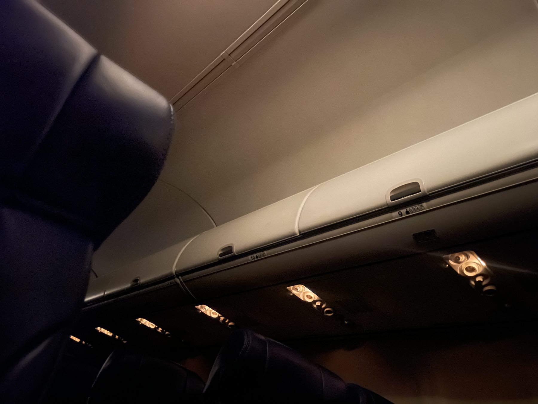 Plane cabin lit by incandescent light
